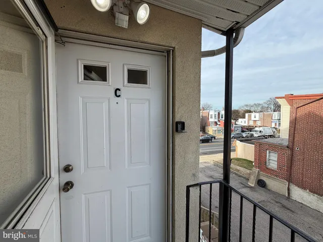 a view of a hallway with wooden floor and entryway