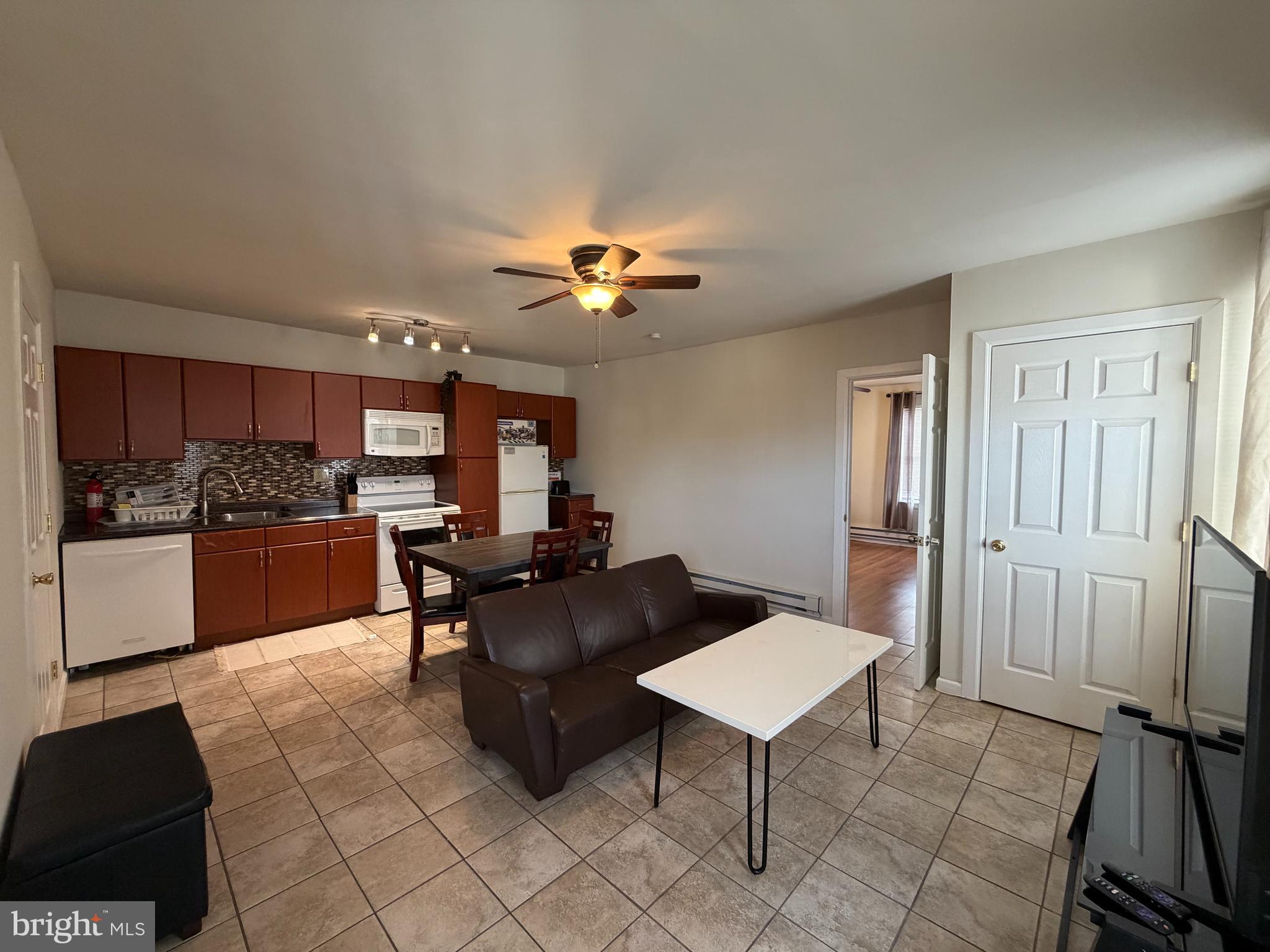 7103 Rising Sun Avenue, Unit C Philadelphia, PA 19111 - Photo 5 of 19 a living room with furniture and kitchen view