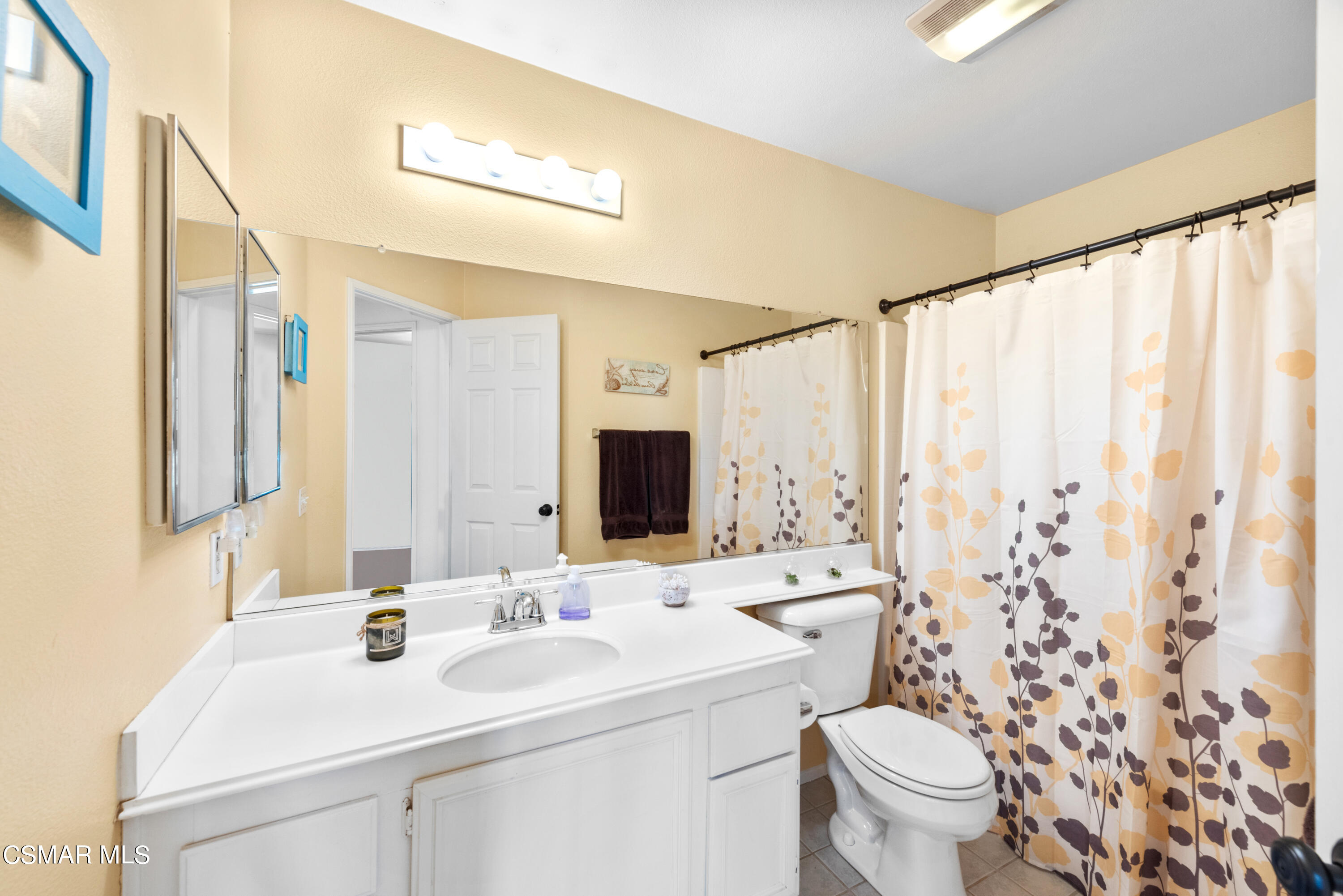 5248 Portia Street Simi Valley, CA 93063 - Photo 28 of 45 a bathroom with a sink a toilet and a mirror