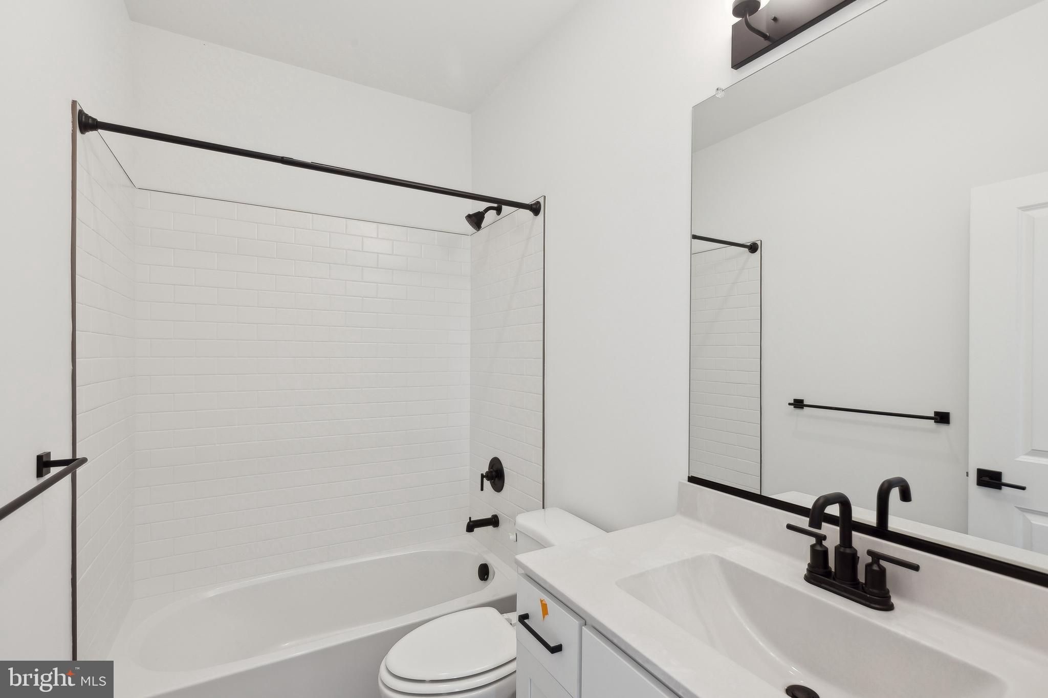 36332 Gate Drive Georgetown, DE 19947 - Photo 18 of 30 a bathroom with a sink toilet and shower