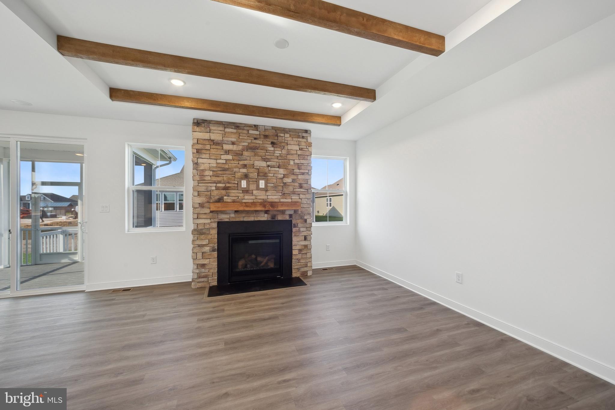 36332 Gate Drive Georgetown, DE 19947 - Photo 10 of 30 a view of empty room with wooden floor and fireplace