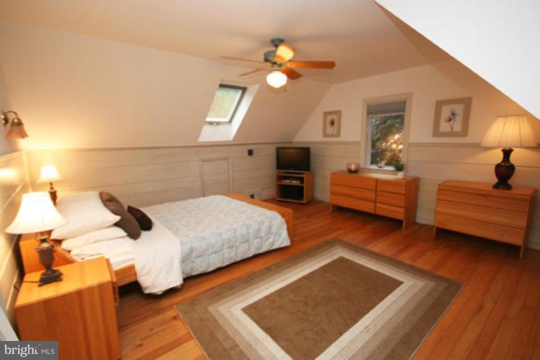 9220 Whitney Street Silver Spring, MD 20901 - Photo 12 of 30 a bedroom with furniture and a fireplace