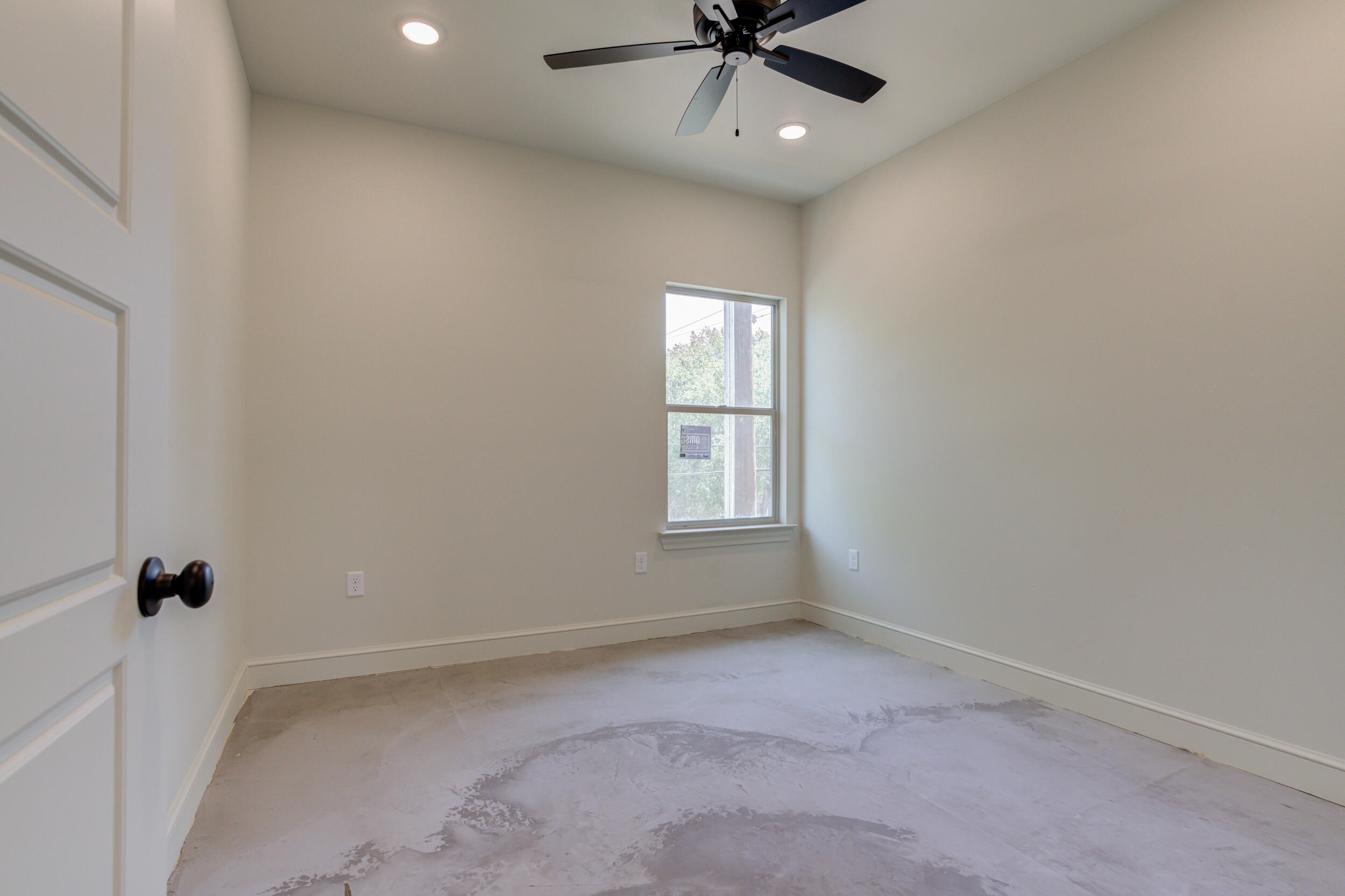 3419 24th Street Lubbock, TX 79410 - Photo 36 of 45 an empty room with a window and a fan