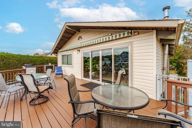 a living room with furniture a wooden floor and a large window