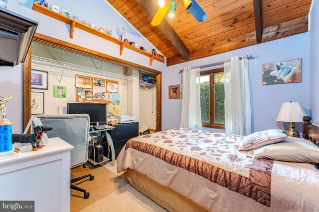 an aerial view of residential houses with outdoor space and parking