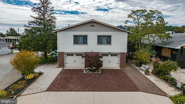 a view of a house with backyard porch and sitting area