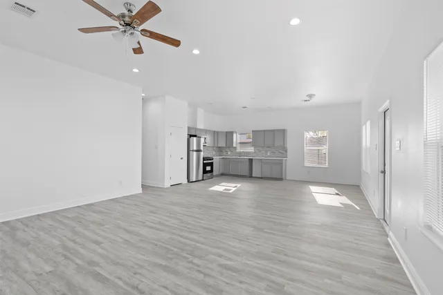 a view of kitchen with stainless steel appliances refrigerator microwave and stove