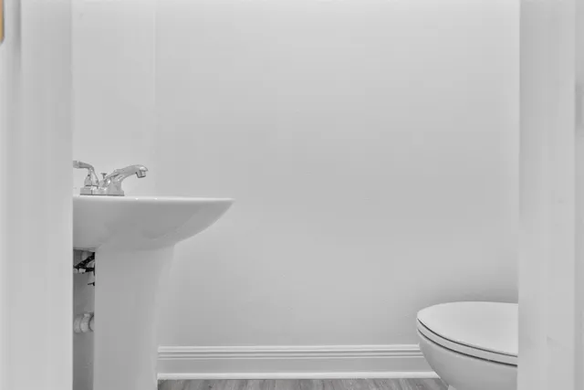 a view of a room with wooden floor and natural light