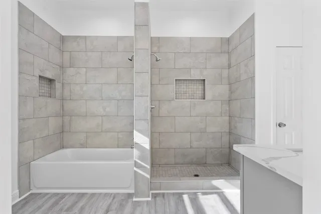 a bathroom with a granite countertop sink a toilet and shower