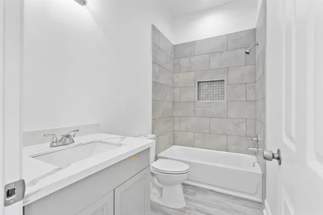 a bathroom with a toilet a sink and bathtub