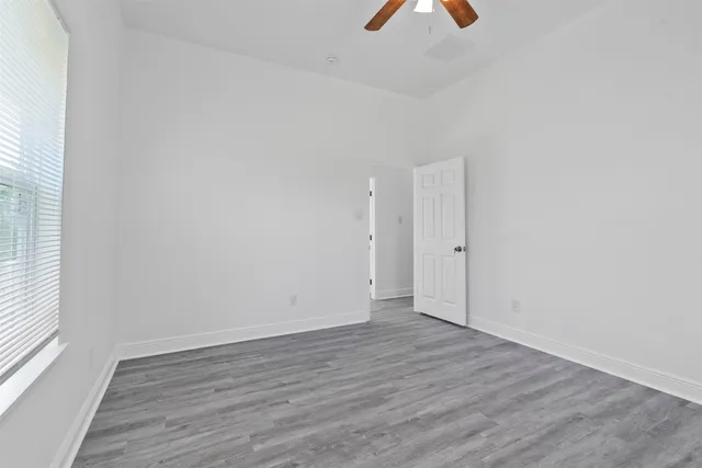 wooden floor in an empty room with a window
