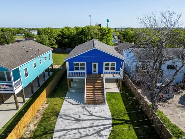 an aerial view of residential house with outdoor space and trees