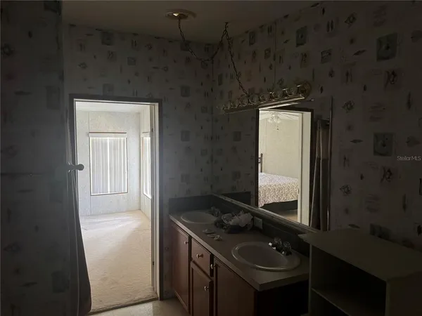 a bedroom with a bed and a ceiling fan