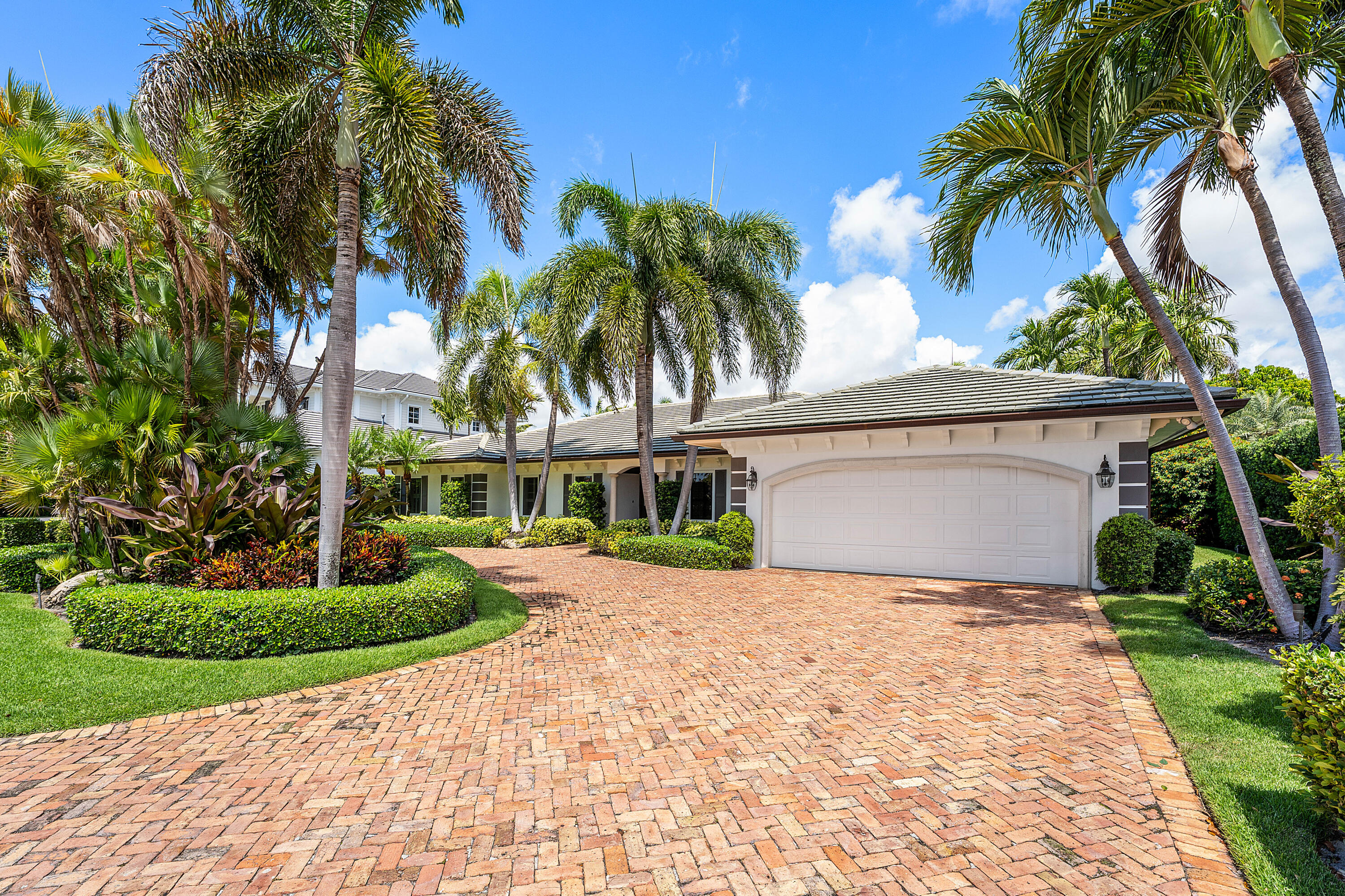 1851 Thatch Palm Drive Boca Raton, FL 33432 - Photo 3 of 70 a view of a house with a yard and palm trees