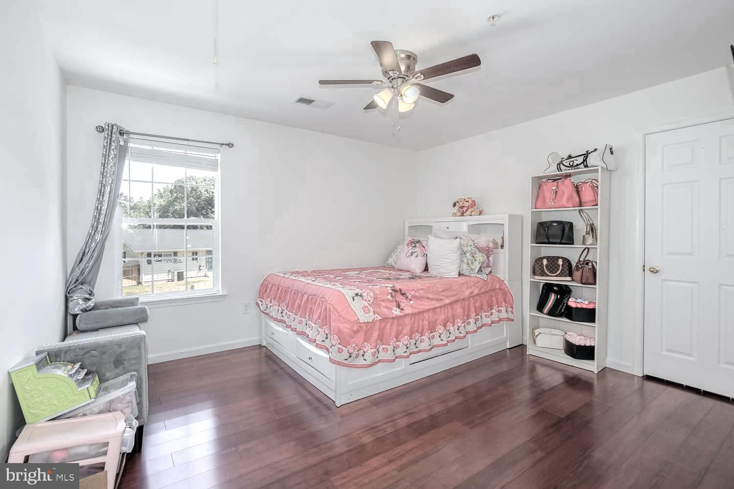 6810 Ashleys Crossing Court Temple Hills, MD 20748 - Photo 32 of 45 a bedroom with a bed and a chandelier