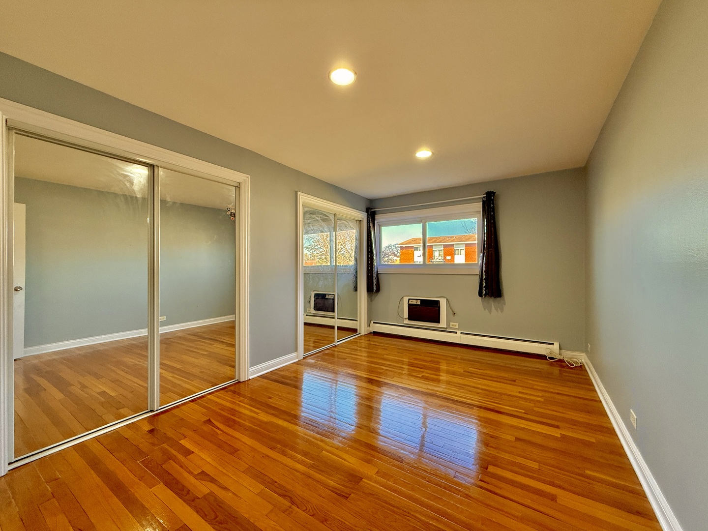 9561 Dee Road, Unit 107G Des Plaines, IL 60016 - Photo 11 of 12 a view of an empty room with window and wooden floor