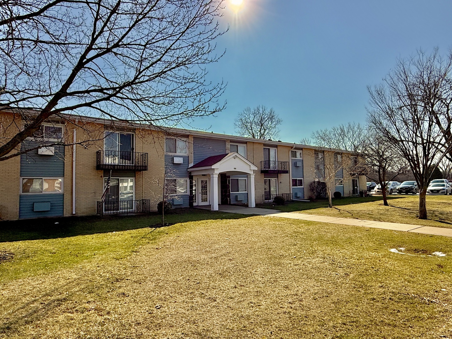 9561 Dee Road, Unit 107G Des Plaines, IL 60016 - Photo 2 of 12 a front view of a house with a yard