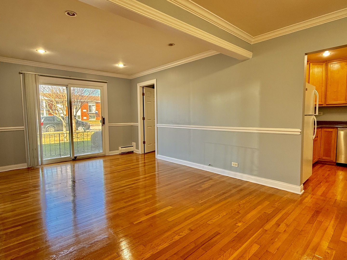 9561 Dee Road, Unit 107G Des Plaines, IL 60016 - Photo 4 of 12 a view of empty room with wooden floor and fan