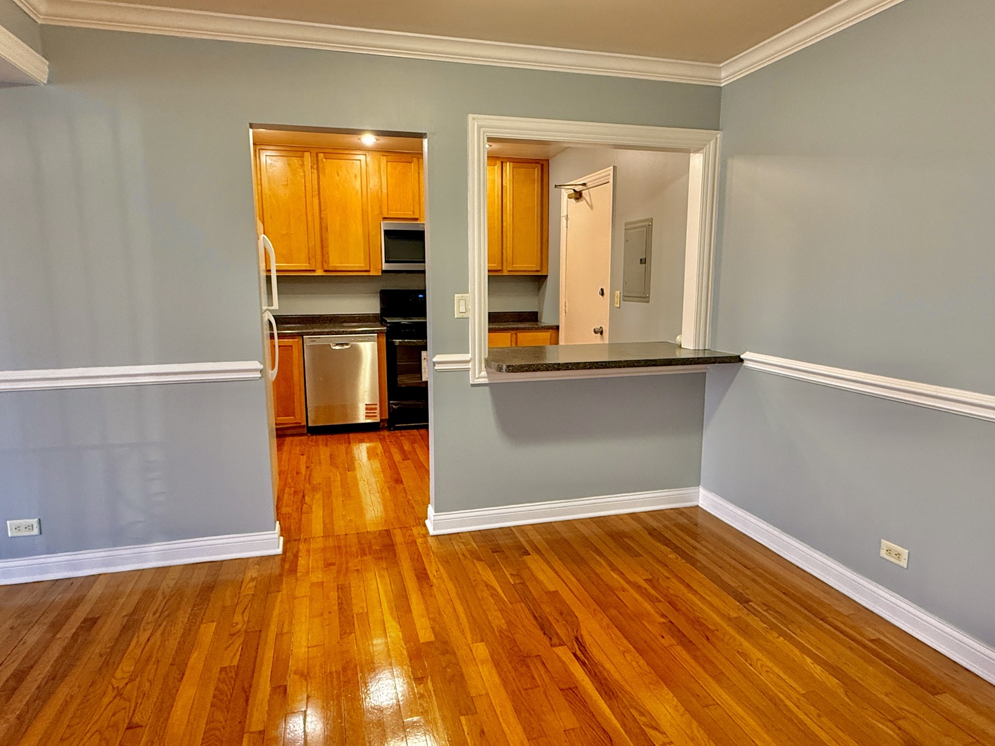 9561 Dee Road, Unit 107G Des Plaines, IL 60016 - Photo 5 of 12 a view of a kitchen with wooden floor and a window
