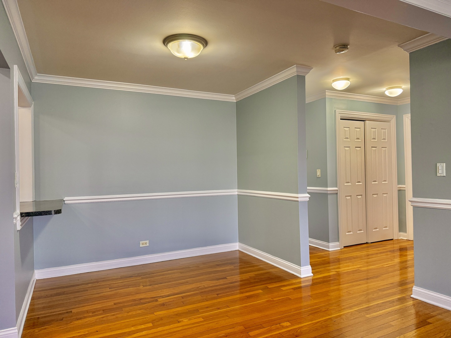 9561 Dee Road, Unit 107G Des Plaines, IL 60016 - Photo 6 of 12 a view of an empty room with wooden floor