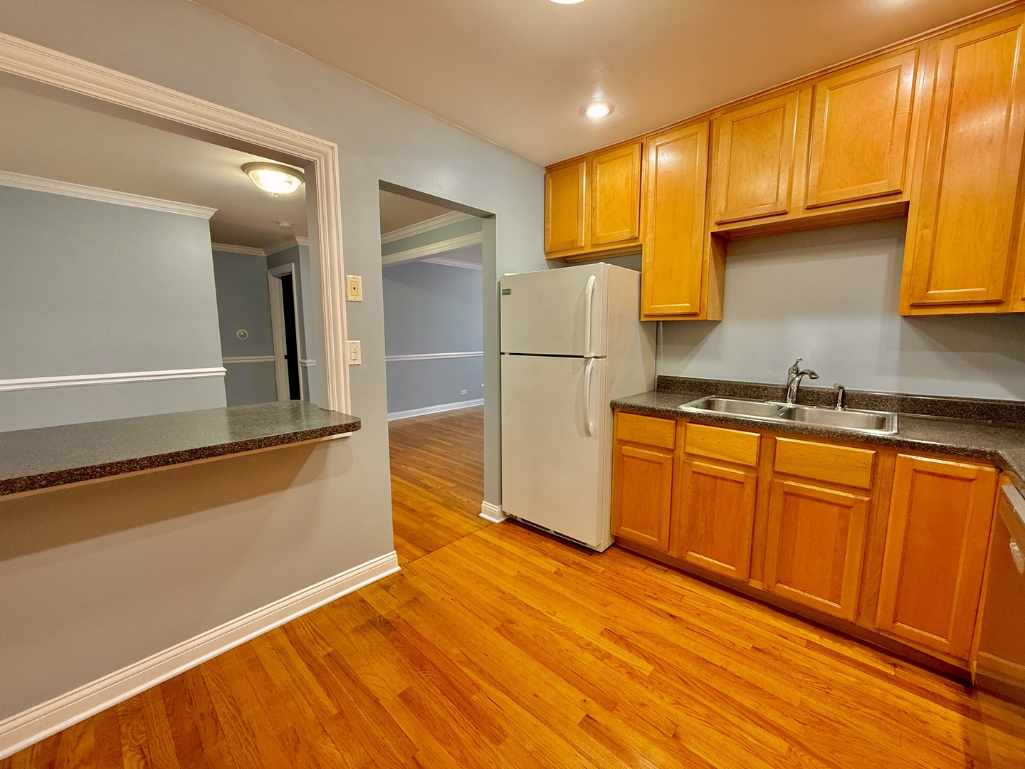 9561 Dee Road, Unit 107G Des Plaines, IL 60016 - Photo 8 of 12 a kitchen with stainless steel appliances granite countertop a refrigerator and a stove top oven