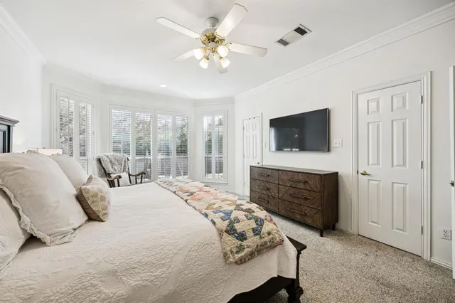 a bedroom with a bed a chandelier and a fireplace