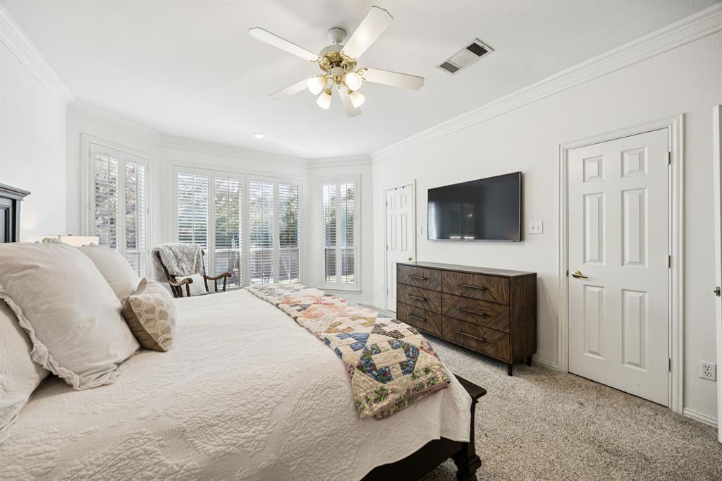 902 Kilgore Court Allen, TX 75013 - Photo 15 of 32 a bedroom with a bed a chandelier and a fireplace