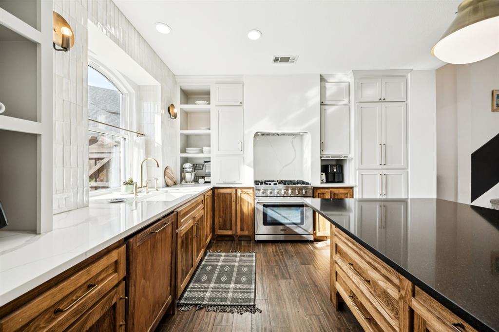 902 Kilgore Court Allen, TX 75013 - Photo 2 of 32 a kitchen with stainless steel appliances granite countertop a stove and a sink