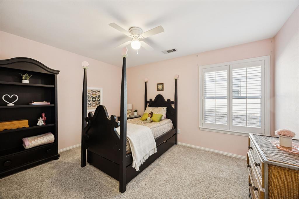 902 Kilgore Court Allen, TX 75013 - Photo 23 of 32 a bedroom with a bed and a chandelier
