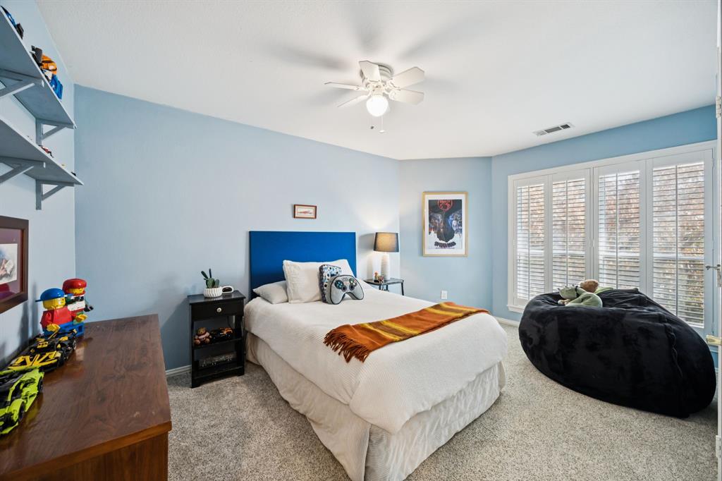 902 Kilgore Court Allen, TX 75013 - Photo 24 of 32 a bedroom with a bed a chandelier and a window