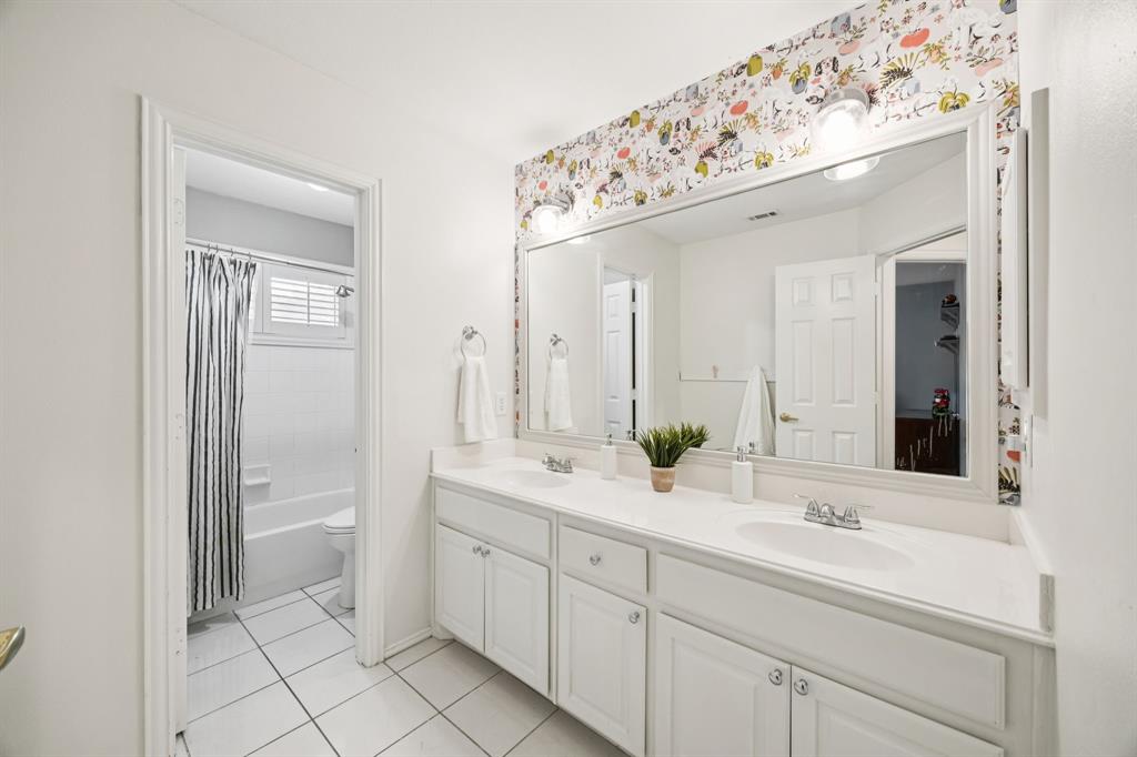 902 Kilgore Court Allen, TX 75013 - Photo 25 of 32 a bathroom with a sink and a mirror