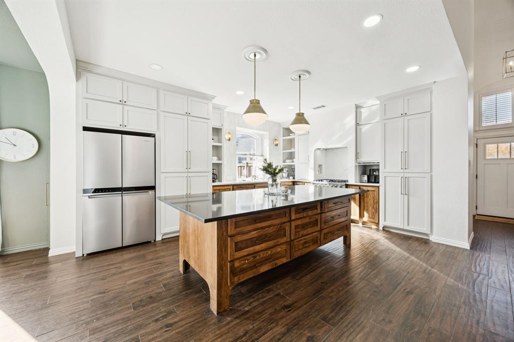 902 Kilgore Court Allen, TX 75013 - Photo 6 of 32 a kitchen with stainless steel appliances kitchen island hardwood floor and a sink