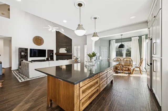 a kitchen with stainless steel appliances granite countertop a stove and a wooden floors