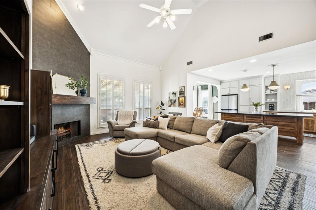 902 Kilgore Court Allen, TX 75013 - Photo 9 of 32 a living room with furniture a fireplace and a flat screen tv