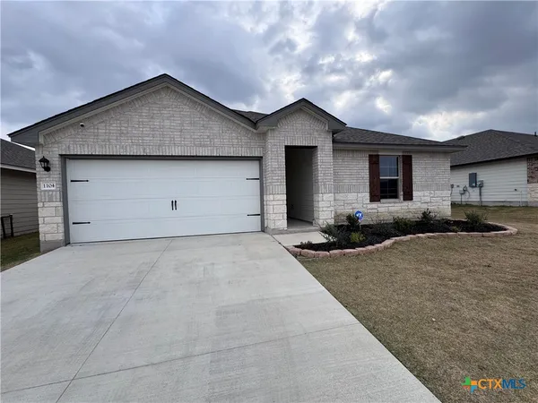 a view of a house with a yard and garage