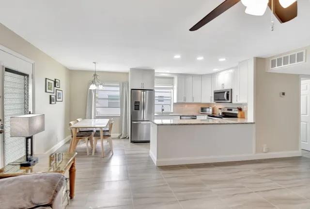 a kitchen with refrigerator cabinets and wooden floor
