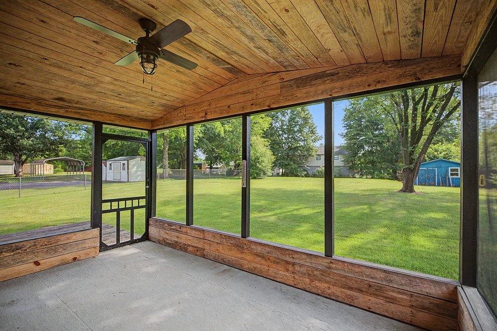 115 Brunson Drive Pickens, SC 29671 - Photo 20 of 29 A breezy screened porch with a rustic wood ceiling, providing tranquil views of a verdant yard and mature trees.