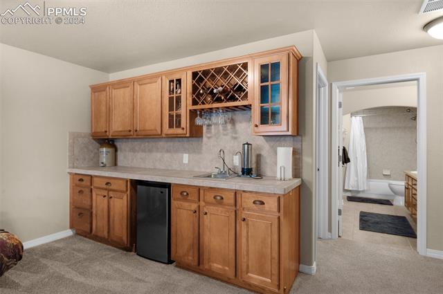 533 Talus Road Monument, CO 80132 - Photo 32 of 46 Kitchen featuring stainless steel fridge, light colored carpet, and sink