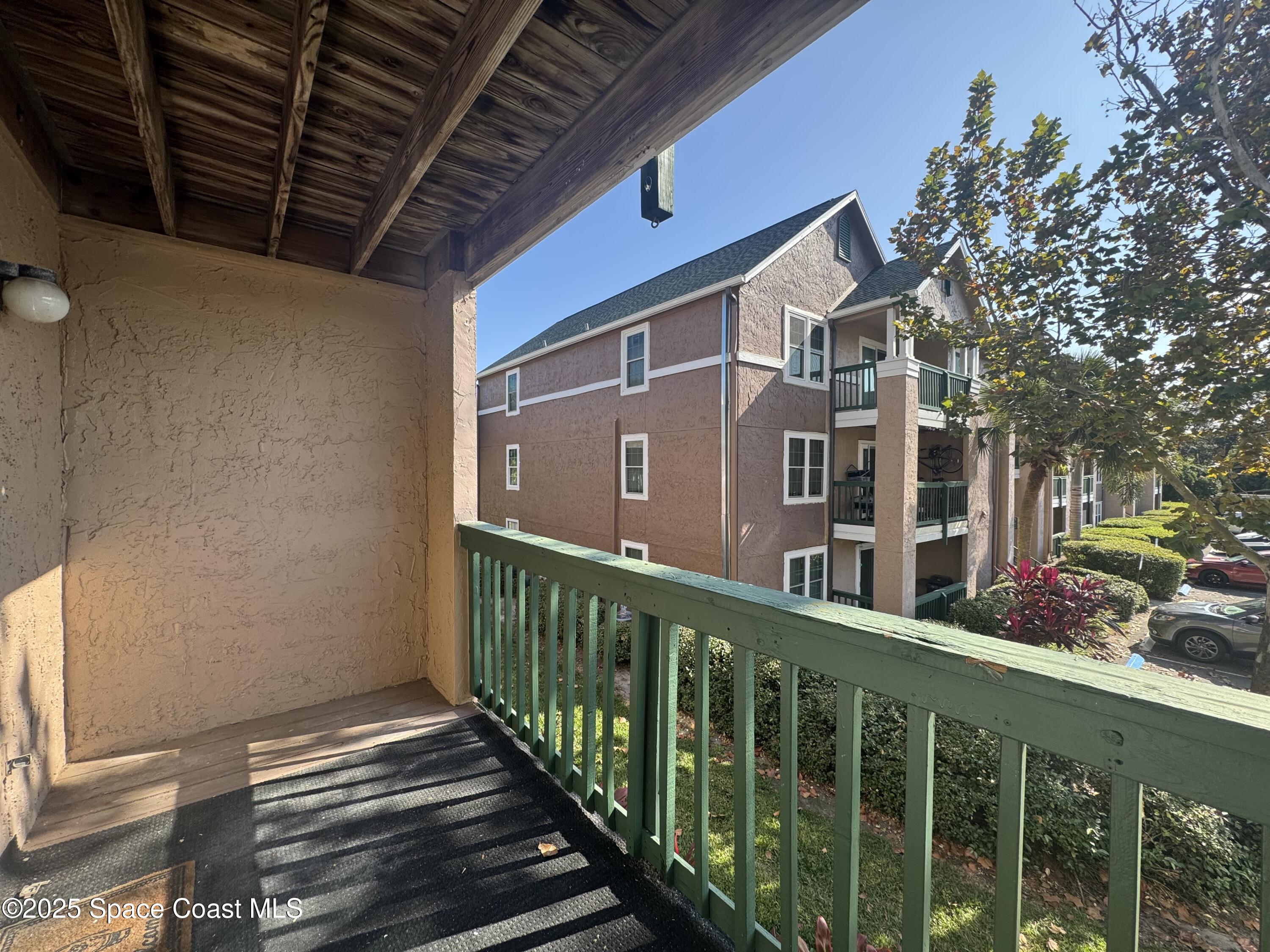 7667 North Wickham Road, Unit 1013 Melbourne, FL 32940 - Photo 11 of 14 a view of a brick house with a small yard