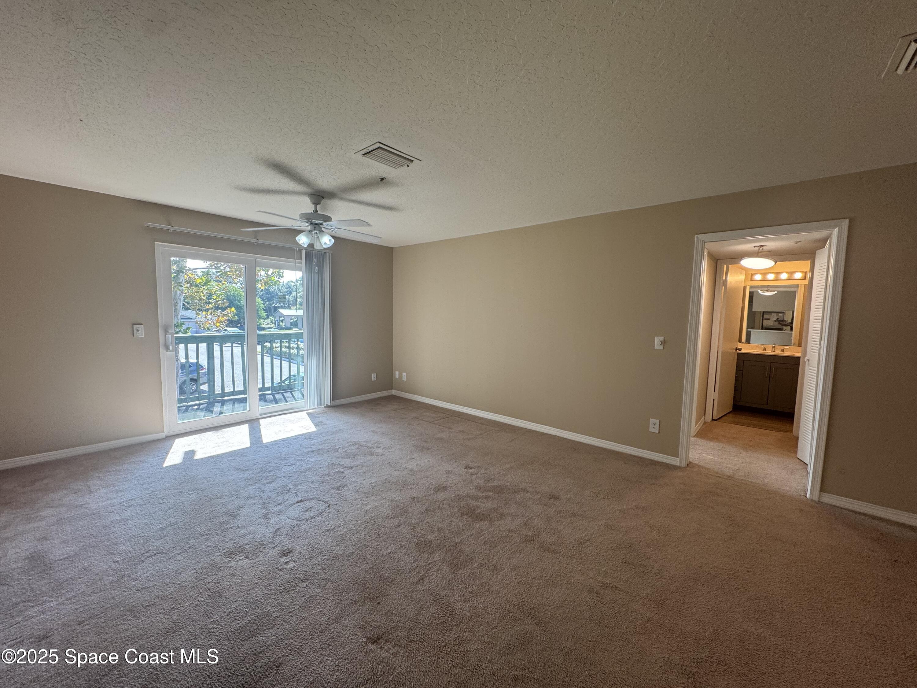 7667 North Wickham Road, Unit 1013 Melbourne, FL 32940 - Photo 4 of 14 a view of an empty room with a window