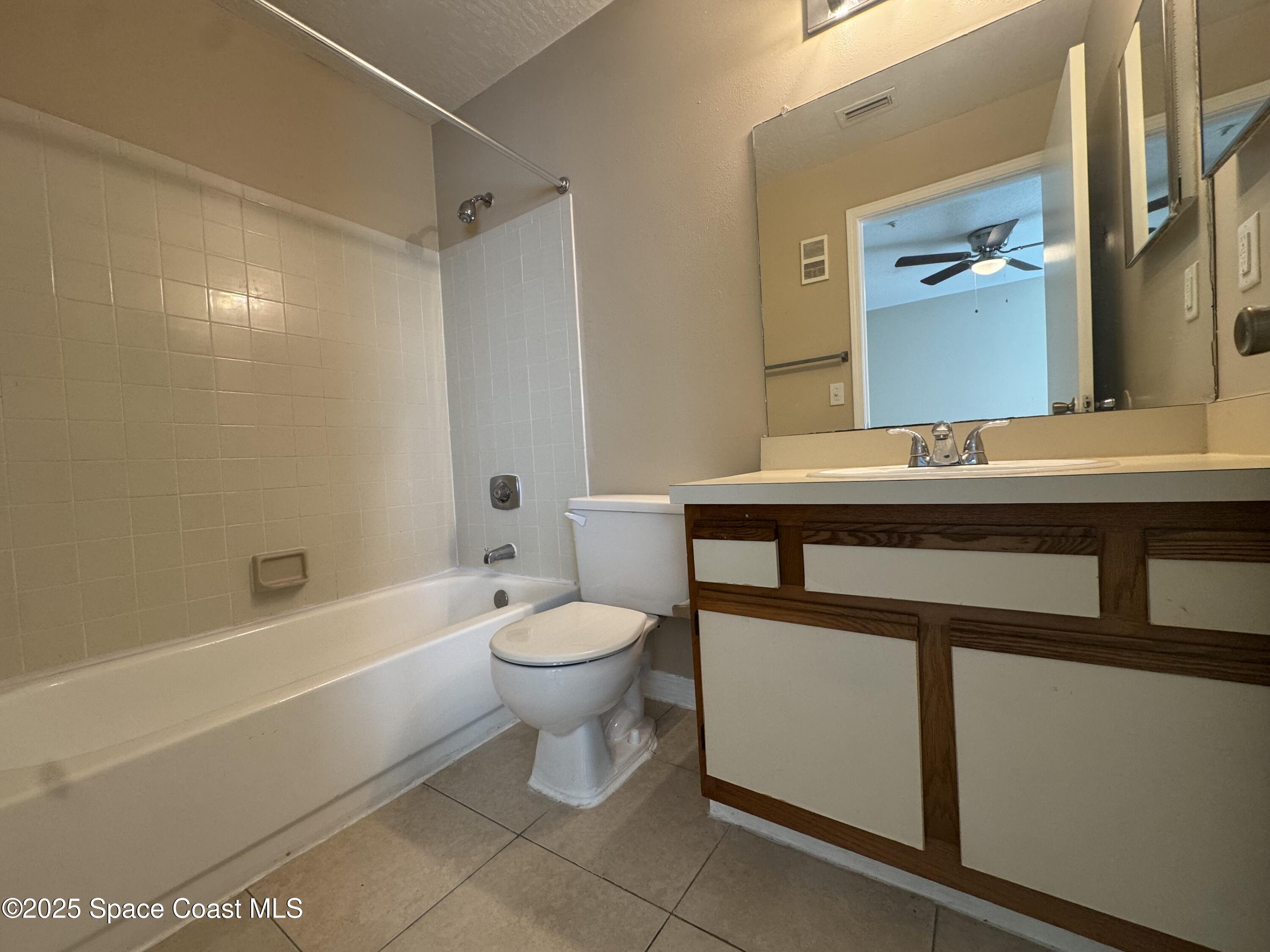 7667 North Wickham Road, Unit 1013 Melbourne, FL 32940 - Photo 10 of 14 a bathroom with a sink a toilet and a bathtub