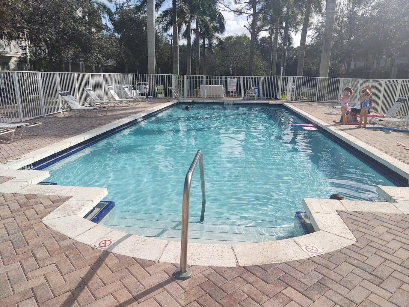 265 Indian Creek Parkway, Unit 102 Jupiter, FL 33458 - Photo 15 of 21 a view of a swimming pool with a patio