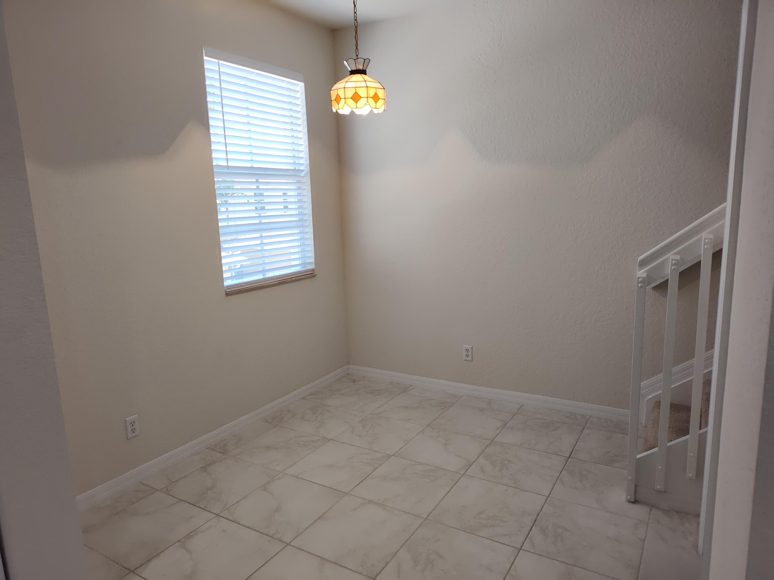265 Indian Creek Parkway, Unit 102 Jupiter, FL 33458 - Photo 8 of 21 an empty room with windows