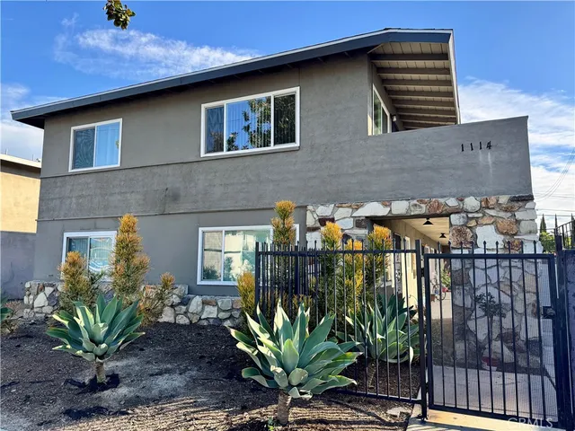 a view of a house with a flower garden
