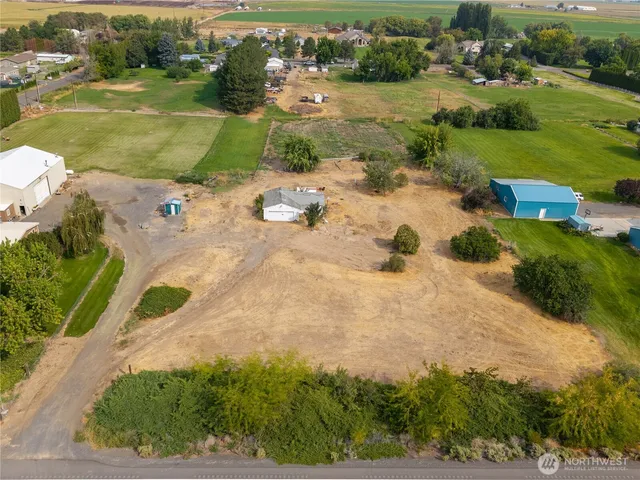 an aerial view of a house with yard