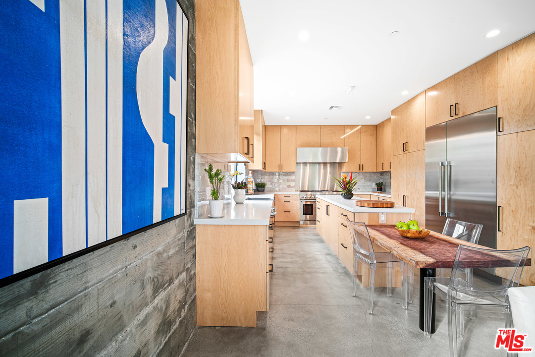 11519 Mississippi Avenue Los Angeles, CA 90025 - Photo 15 of 45 a living room with furniture dining table and a refrigerator