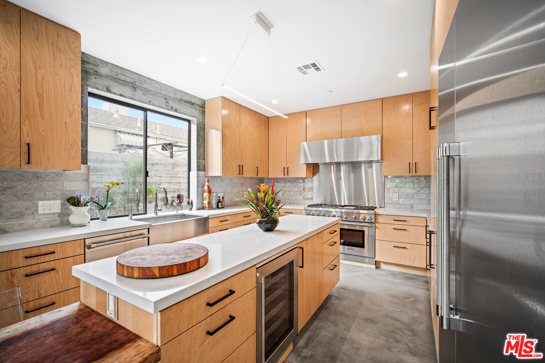 11519 Mississippi Avenue Los Angeles, CA 90025 - Photo 16 of 45 a kitchen with kitchen island granite countertop a sink stove and refrigerator