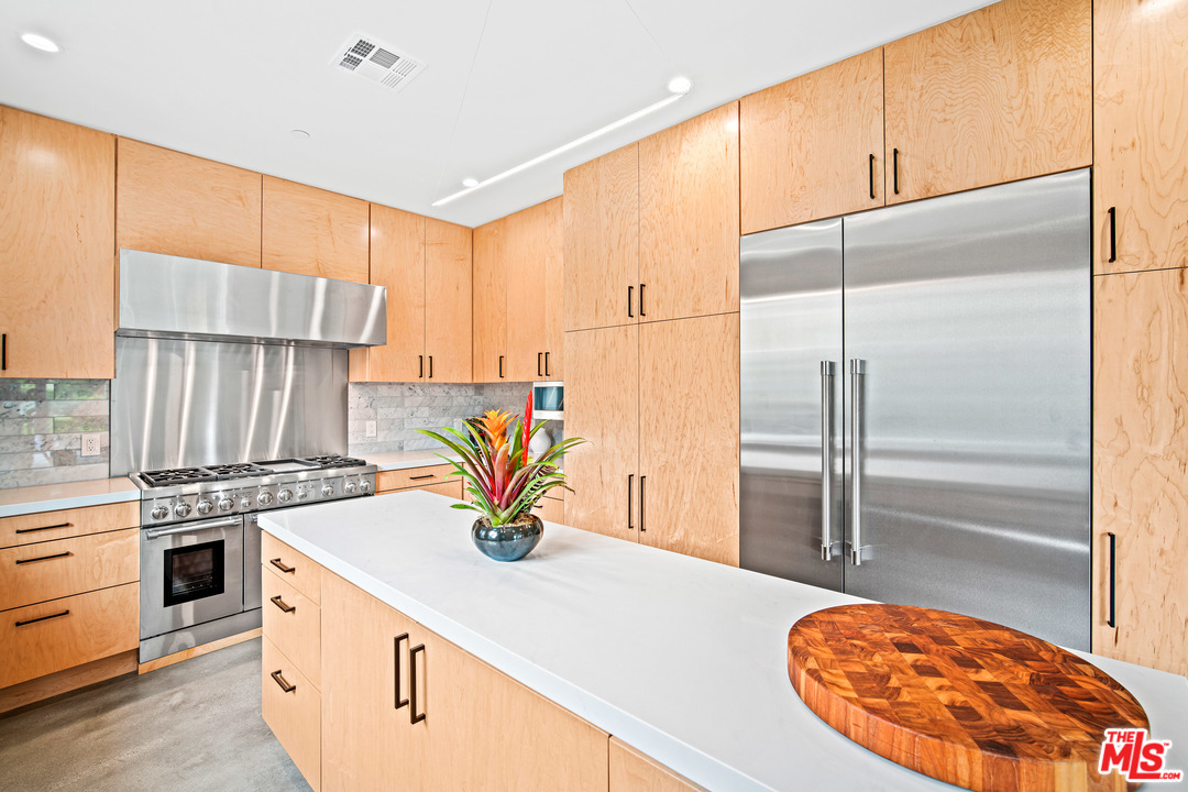 11519 Mississippi Avenue Los Angeles, CA 90025 - Photo 18 of 45 a kitchen with stainless steel appliances granite countertop a stove a sink and a refrigerator