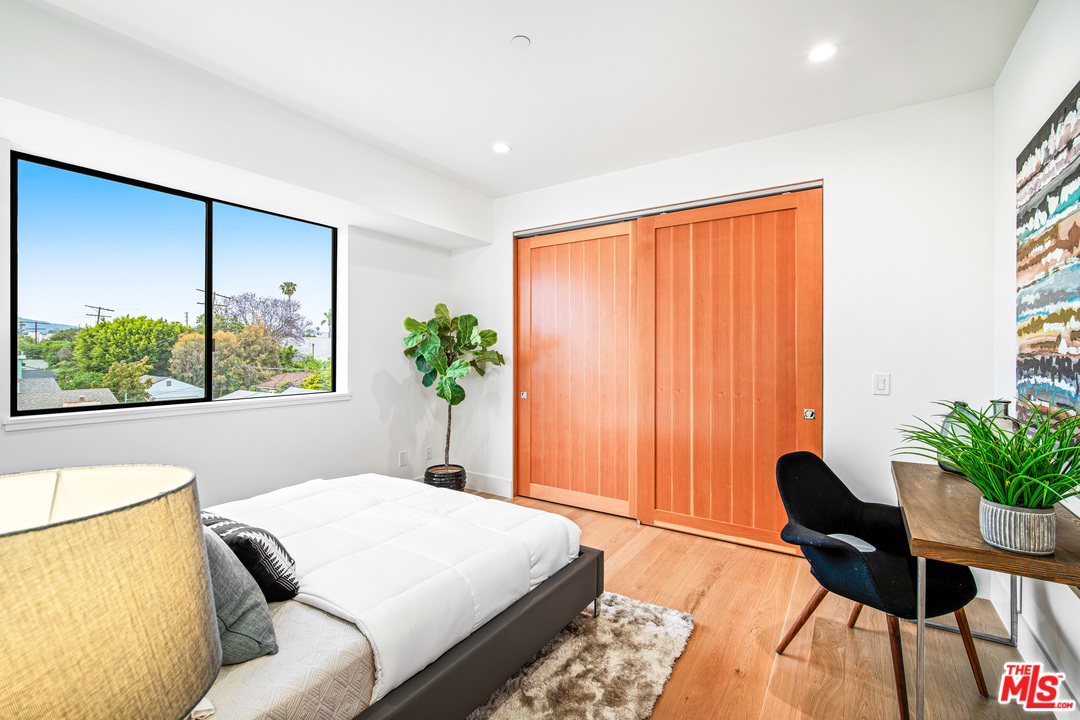 11519 Mississippi Avenue Los Angeles, CA 90025 - Photo 30 of 45 a bedroom with a bed and a large window