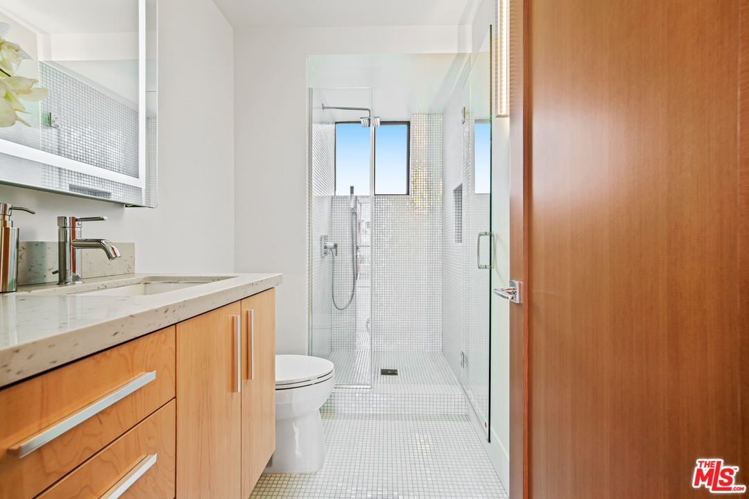 11519 Mississippi Avenue Los Angeles, CA 90025 - Photo 31 of 45 a bathroom with a granite countertop sink toilet and shower